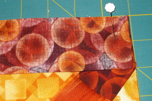 Pin border strip to opposite end of quilt.