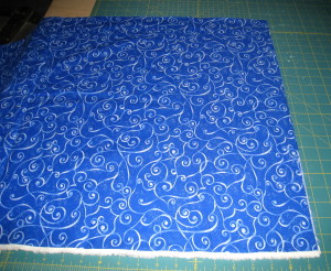 Place fabric on cutting mat.