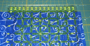 Line up a horizontal line on the ruler with the fabric fold line.