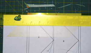 Fold paper over, position ruler and trim off excess fabric.