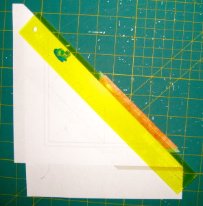 Place ruler on top of paper and template plastic.