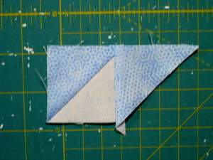 Sew so the triangle is matched with the light fabric of the HST