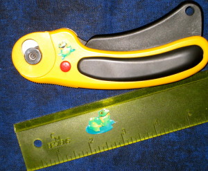 Frogs on my ruler and rotary cutter.