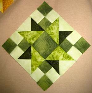 One light, one dark and two medium greens make up this nicely balanced block.