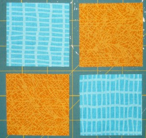 Sew medium turquoise and yellow orange squares together.