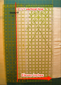 Place the 6 ½″ ruler along side the other ruler lining the 2 ½″ line up on the edge of the fabric.