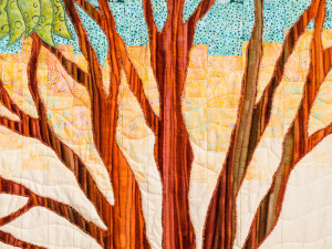 Quilting of background sky and tree on bargello landscape art quilt