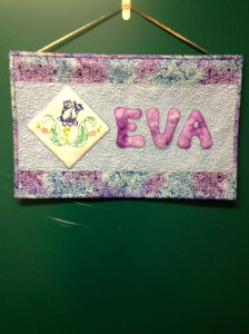 Eva's name quilt hanging on her door.