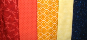 five fabrics that make up a split-complimentary plus scheme