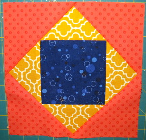 Sew remaining red-orange triangles in place