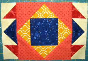 Sew units from step 3 to the sides of the square in a square unit