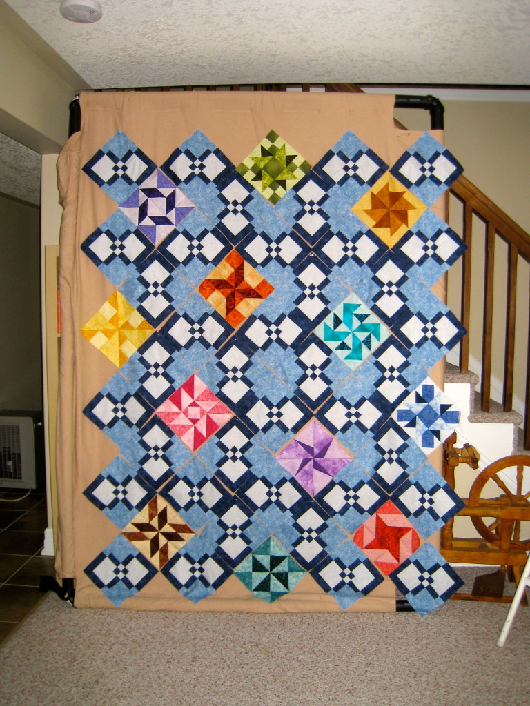 Quilt on the design wall which had to be turned vertical for all the pieces to fit