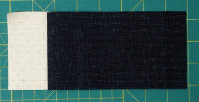 Easy three fabric block with cream and blue large rectangle sewn together