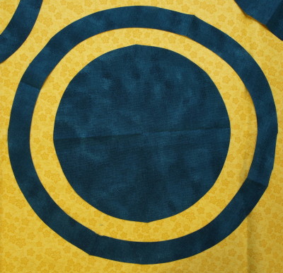 A square of fabric folded in quarters will give you circles and rings