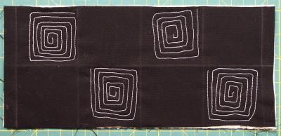 Continuous line square spiral completed in 4 areas of the quilt