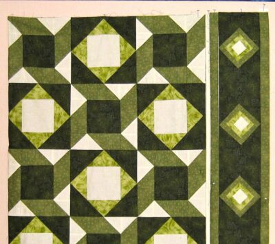 Interwoven designs of two blocks with the dark fabric as the main border fabric