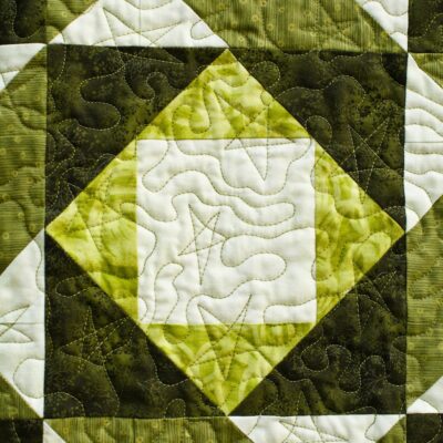 Interwoven designs of two blocks with a close up of the stars quilting motif