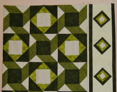 Interwoven designs of two blocks with the light fabric as the main border fabric