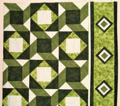 Interwoven designs of two blocks with the bright fabric as the main border fabric