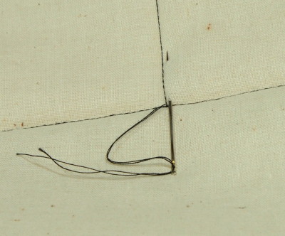 needly pulling thread ends under backing fabric