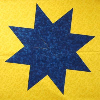 Cutting diamonds from a fabric strip can create an 8 pointed star