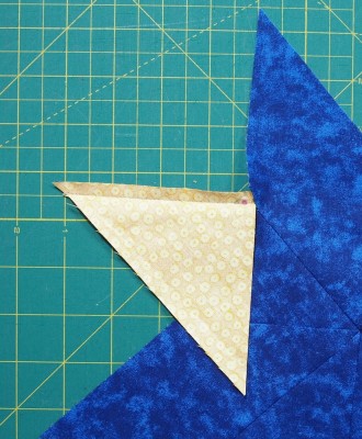 sew to star stopping a ¼″ from end of triangle
