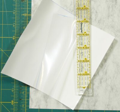 paper being peeled away from the sheet of invisigrip