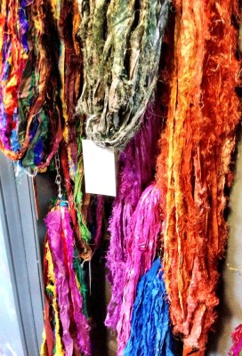 colourful yarn hanging on a wall