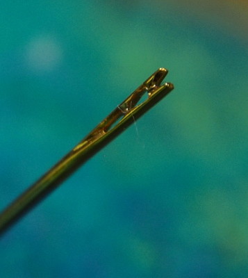a close up of the end of the self-threading needle