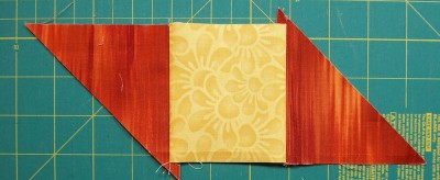 two triangles sewn to yellow square #1