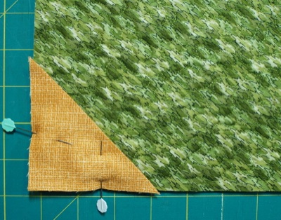 triangle pinned in corner of quilt back