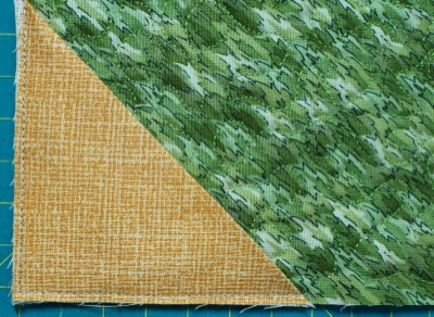 triangle sewn into corner of quilt back