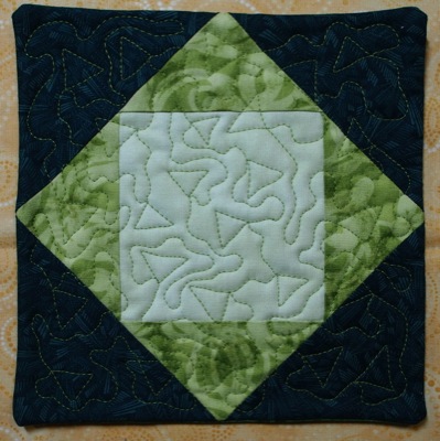 potholder quilted with free motion triangles 