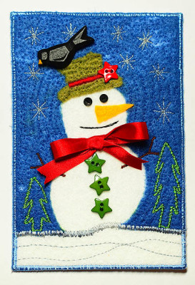 white and blue postcard with snowman