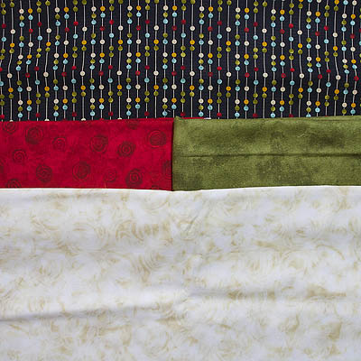 fabrics in cream, green, red and brown with coloured circles
