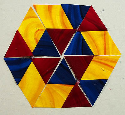 hexagon made of red & blue triangles and yellow diamonds