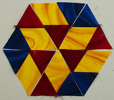 Triangle shape of yellow and red within a border of yellow, red & blue