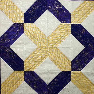 X and O design in yellow and purple with quilting lines