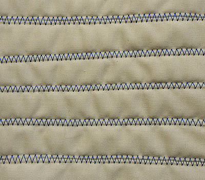 Several lines of zigzag stitch in blue thread