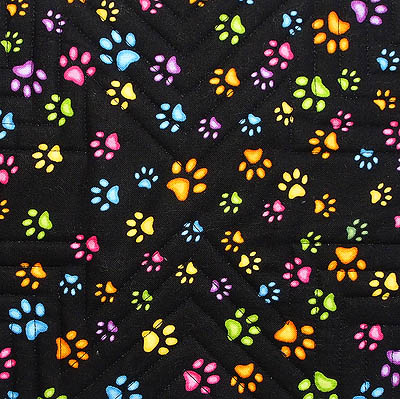 the backing fabric is multi-coloured neon paw prints