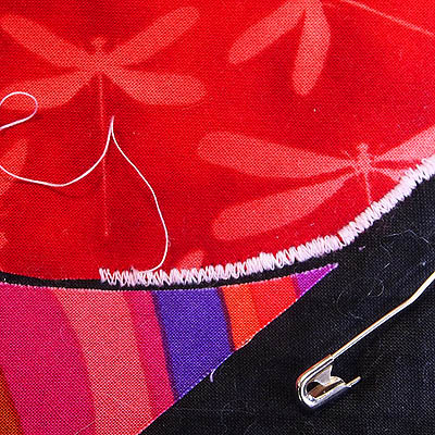 red appliqué shape stitched with free motion satin stitch