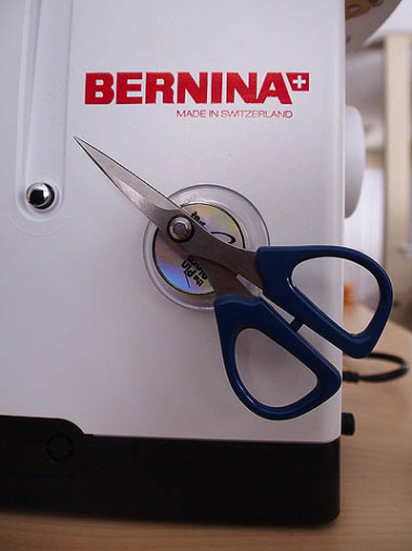 Scissors attached to machine with the magnetic spot