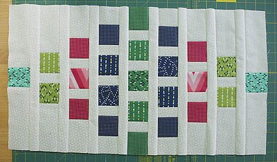Background fabric spacer pieces added between each row