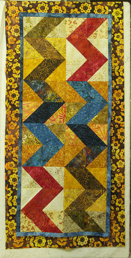 Zigzag runner with a bold yellow/brown flower print border