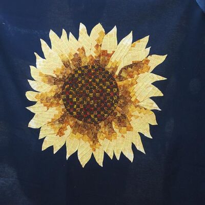 A sunflower fused to a background fabric