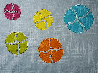 Blanket stitch around each shape in rayon threads to match the colour of the applique