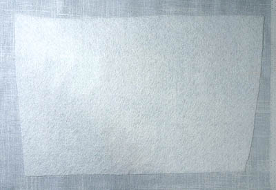 White fleece stabilizer on back of grey fabric