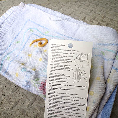 Instructions on back of package and cleaner on the towel