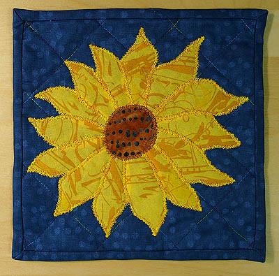 A small sunflower on a blue back ground