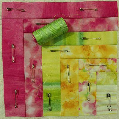 Green spool of thread on quilt block